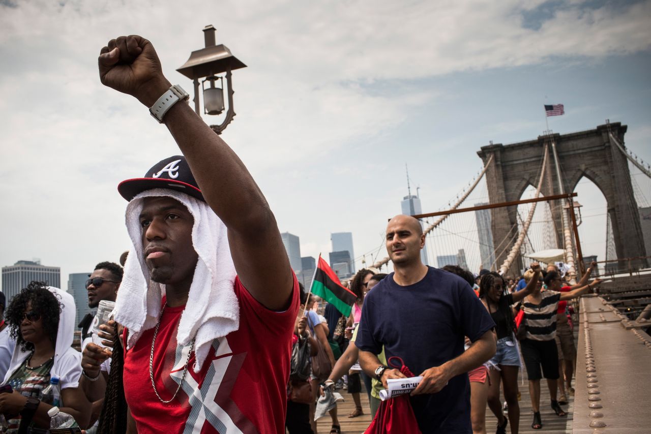 Protesters march across the Brooklyn Bridge toward Brooklyn after attending the rally in Manhattan on July 20.