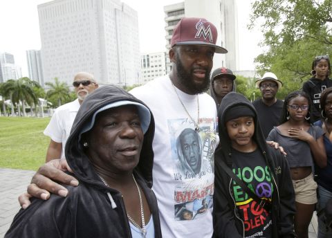 Tracy Martin, father of Trayvon Martin, poses for a photo with supporters wearing hoodies at the rally in Miami on July 20.