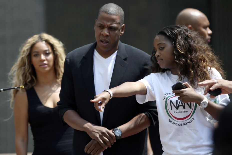Beyoncé, left, and Jay-Z, center, arrive at the rally in New York City on July 20.