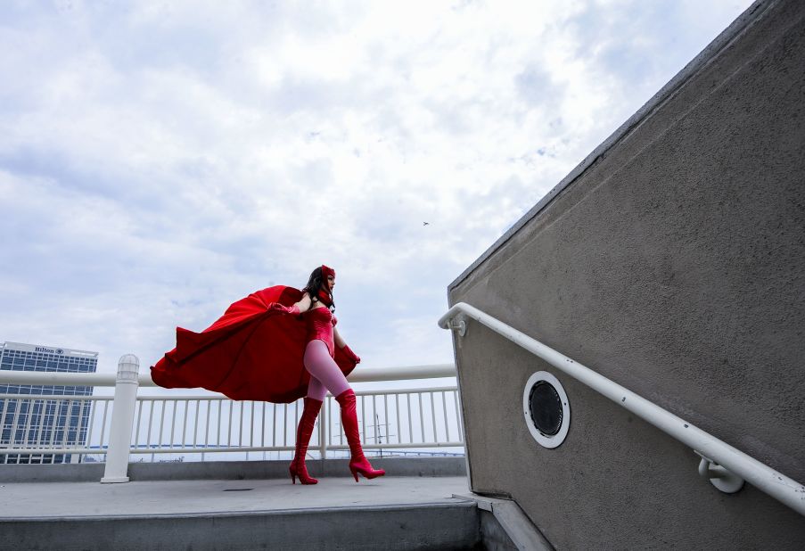 Gillian Owen, dressed as fictional comic book character Scarlet Witch, poses on a walkway during a photo shoot with another photographer on Day 4 of Comic-Con on  July 20. 