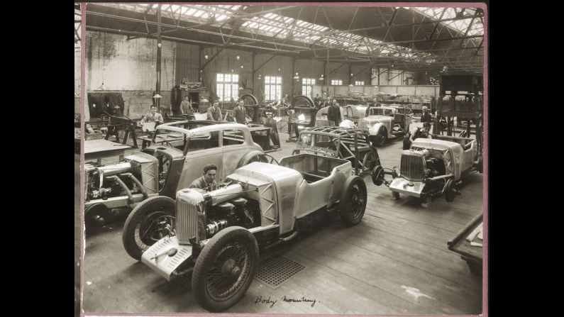Cars move down the Aston Martin Mark II production line, circa 1935.