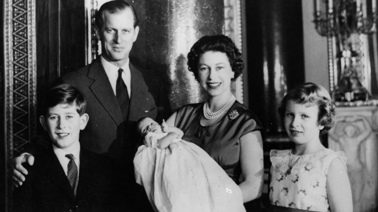 Queen Elizabeth II holds newborn Prince Andrew in the music room of Buckingham Palace in March 1960. Prince Charles, from left, Prince Philip and Princess Anne are by her side.