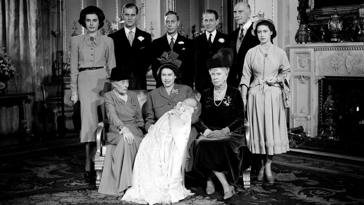 Then-Princess Elizabeth holds son Prince Charles after his christening at Buckingham Palace in December 1948.