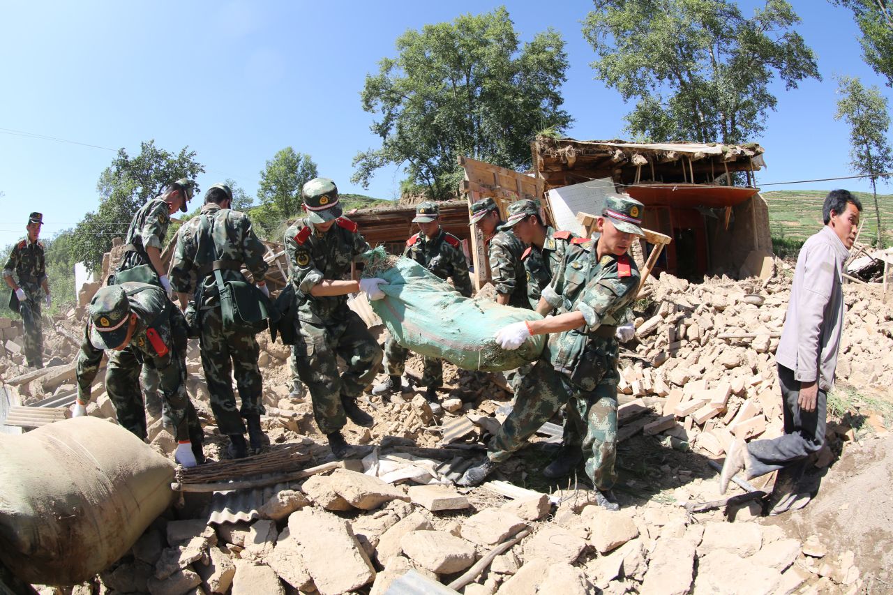 Rescuers clean up debris at Lalu village in Minxian on July 22.