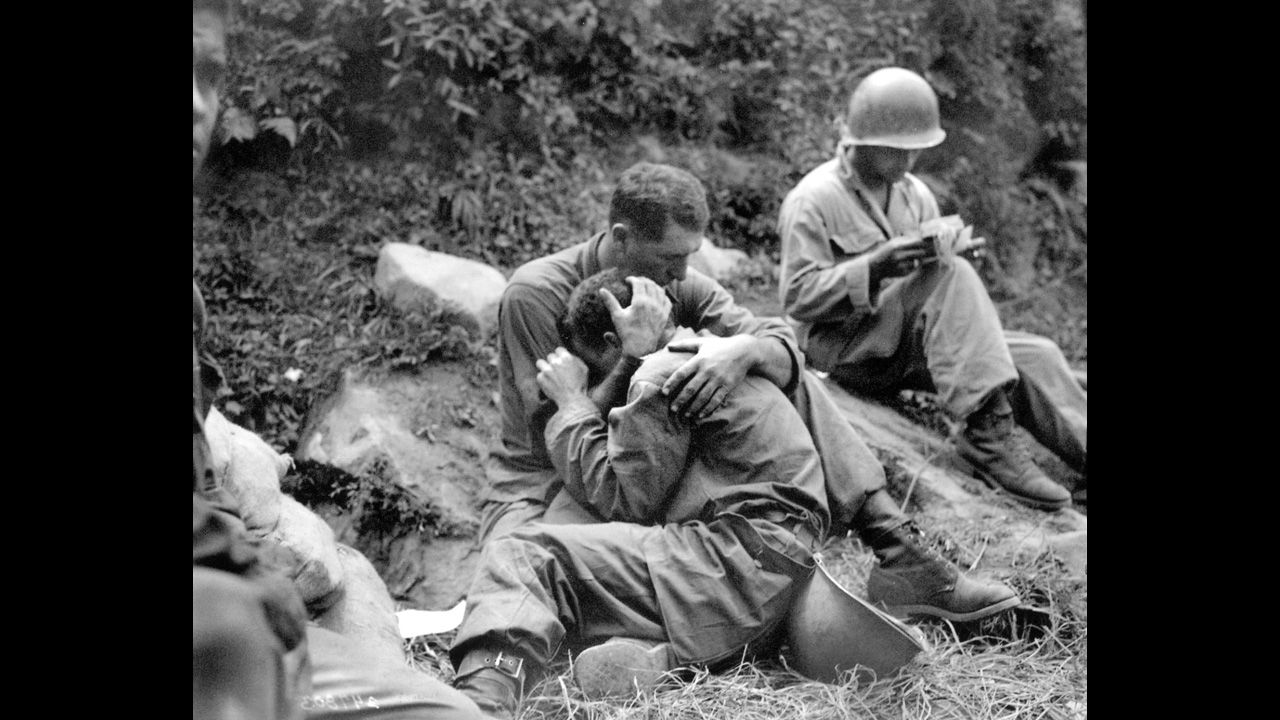An American soldier comforts a comrade during the Korean War, circa 1950. Click through to see more scenes from the Korean War.
