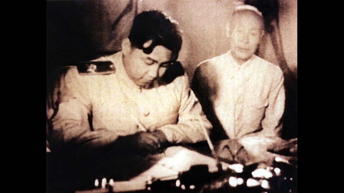 North Korean leader Kim Il-Sung, left, signs a document in Seoul, South Korea, in an undated photo. The armistice ending the war was signed in July 1953, and its terms included the creation of the Demilitarized Zone.