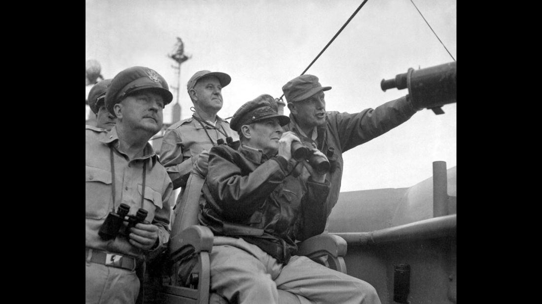 Gen. Douglas MacArthur, center, head of the U.N. Command in the Korean War, and other military personnel observe shelling in Incheon from the USS Mount McKinley in September 1950.