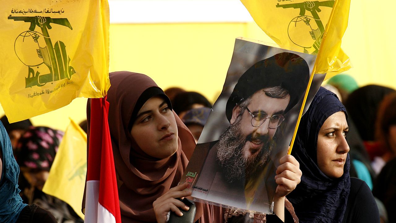 Women hold Hezbollah flags and a picture of the movement's chief, Hassan Nasrallah, in Lebanon on May 25.