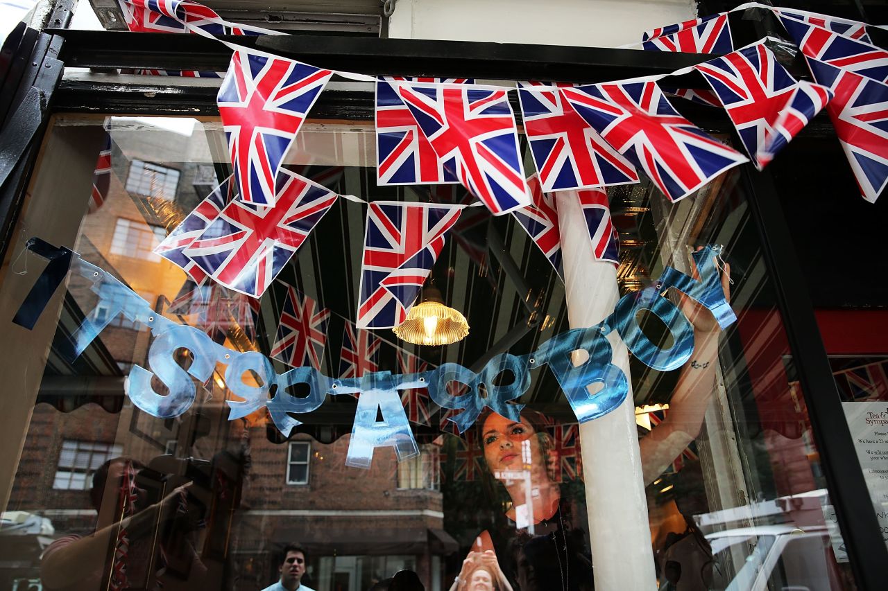 Hayley Simmonds, an employee at the British restaurant and grocery Tea & Sympathy, celebrates the birth on July 22 by hanging a sign in the store's window in New York.