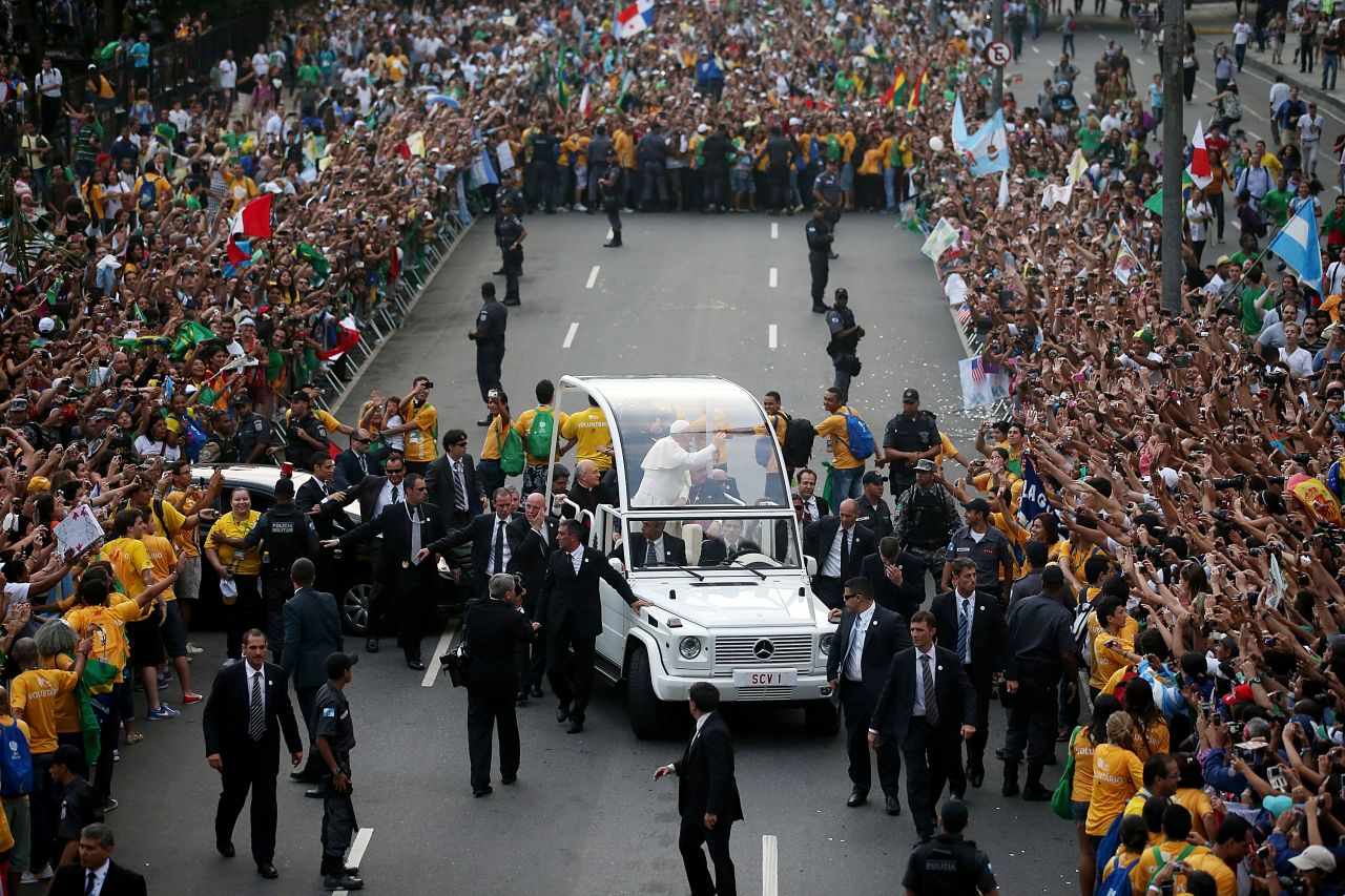 A crowd surrounds the Popemobile on July 22 as Pope Francis departs the Metropolitan Cathedral.