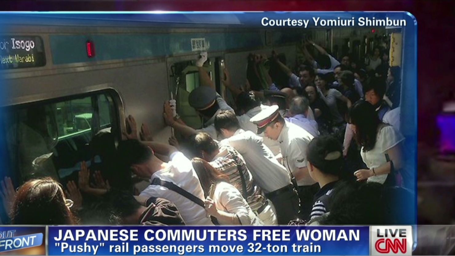Dozens of Japanese commuters help free a woman stuck between the platform and a 32-ton train.