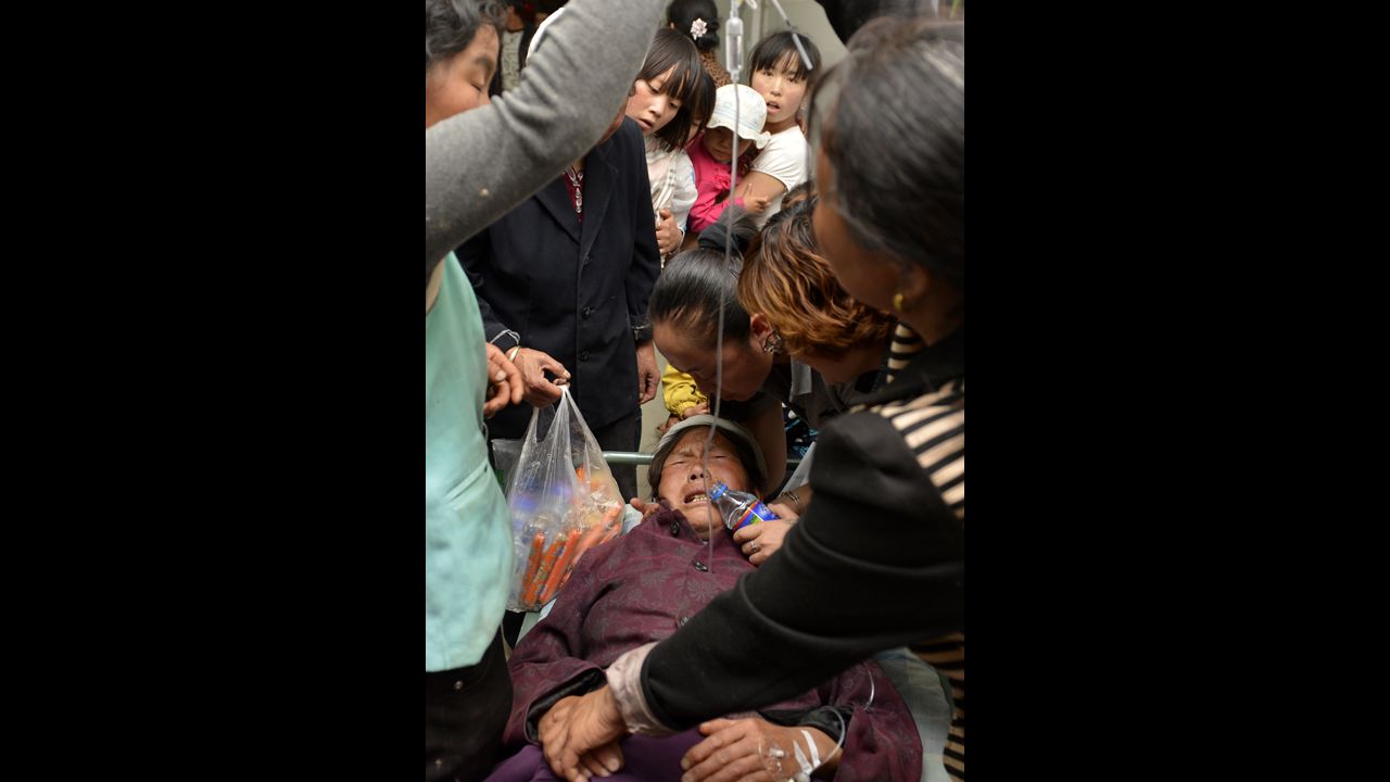 An injured woman receives treatment at a hospital in Minxian County, northwest Gansu Province, on July 22.