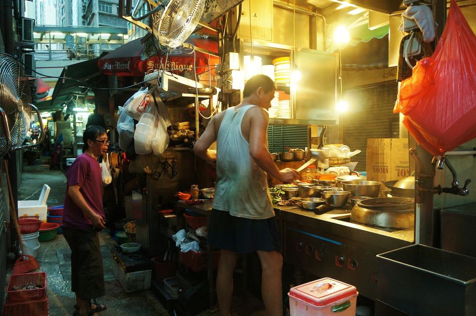 Street food chef Lam Tse-Sing prepares a meal at his dai pai dong, called Sing Kee, in Hong Kong's Central district. Despite their dwindling number, the outdoor street food stalls continue to be celebrated for their traditional flavor and festive atmosphere. 