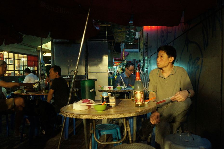 A diner waits for his meal at a dai pai dong in Hong Kong's central district on June 21, 2013. Once a common fixture of Hong Kong street life, now only 28 licensed dai pai dong remain in the city.
