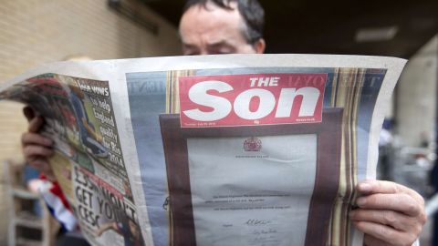 A man reads a copy of British tabloid The Sun, renamed "The Son," on July 23.