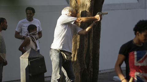 A man fires a gun during clashes between opponents and supporters of Morsy in Cairo on July 22.