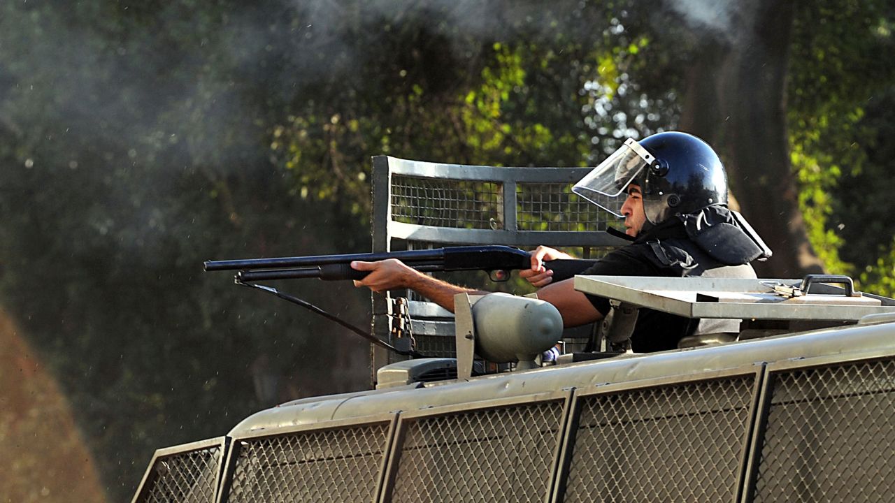A riot police officer aims rubber bullets toward Morsy supporters in Cairo on July 22.