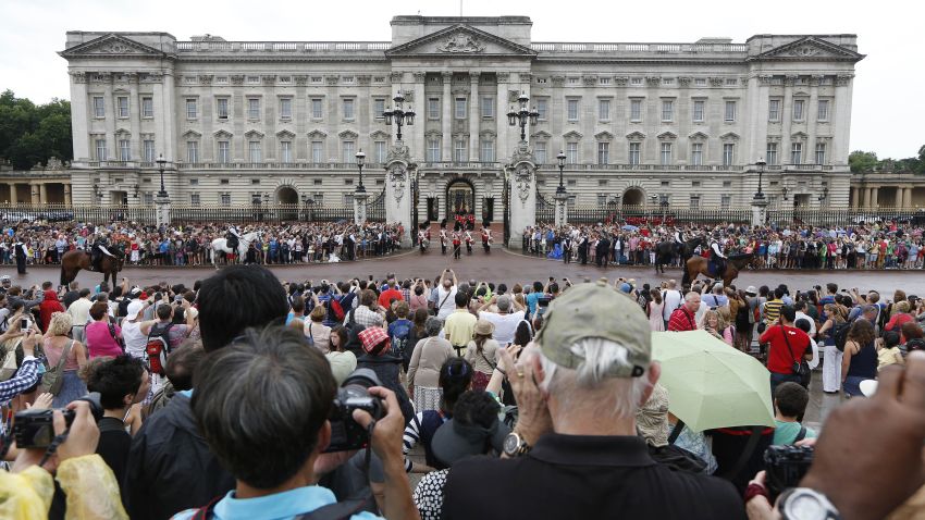 People watch the Changing of the Guard at Buckingham Palace in London, on July 23.