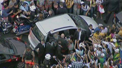 Pope Francis' car is surrounded by well-wishers after the driver took a wrong turn along the route from the Rio de Janeiro airport to the Metropolitan Cathedral on July 22 in this still image taken from video.
