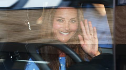 Catherine waves to the crowd gathered outside the hospital.