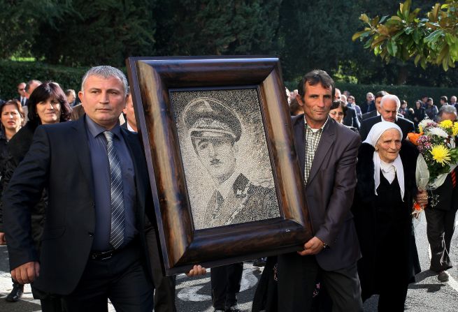 After being booted out of Albania in 1939, the dictatorial King Zog's unlikely residence was Parmoor House, in Buckinghamshire -- it's currently a religious retreat. Here, supporters of the self-titled Zog carry his portrait at a reburial ceremony in Tirana.