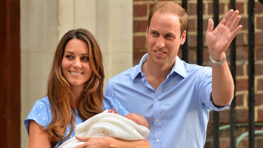 Prince William (R) and Catherine, Duchess of Cambridge show their new-born baby boy to the world's media outside the Lindo Wing of St Mary's Hospital in London on July 23, 2013