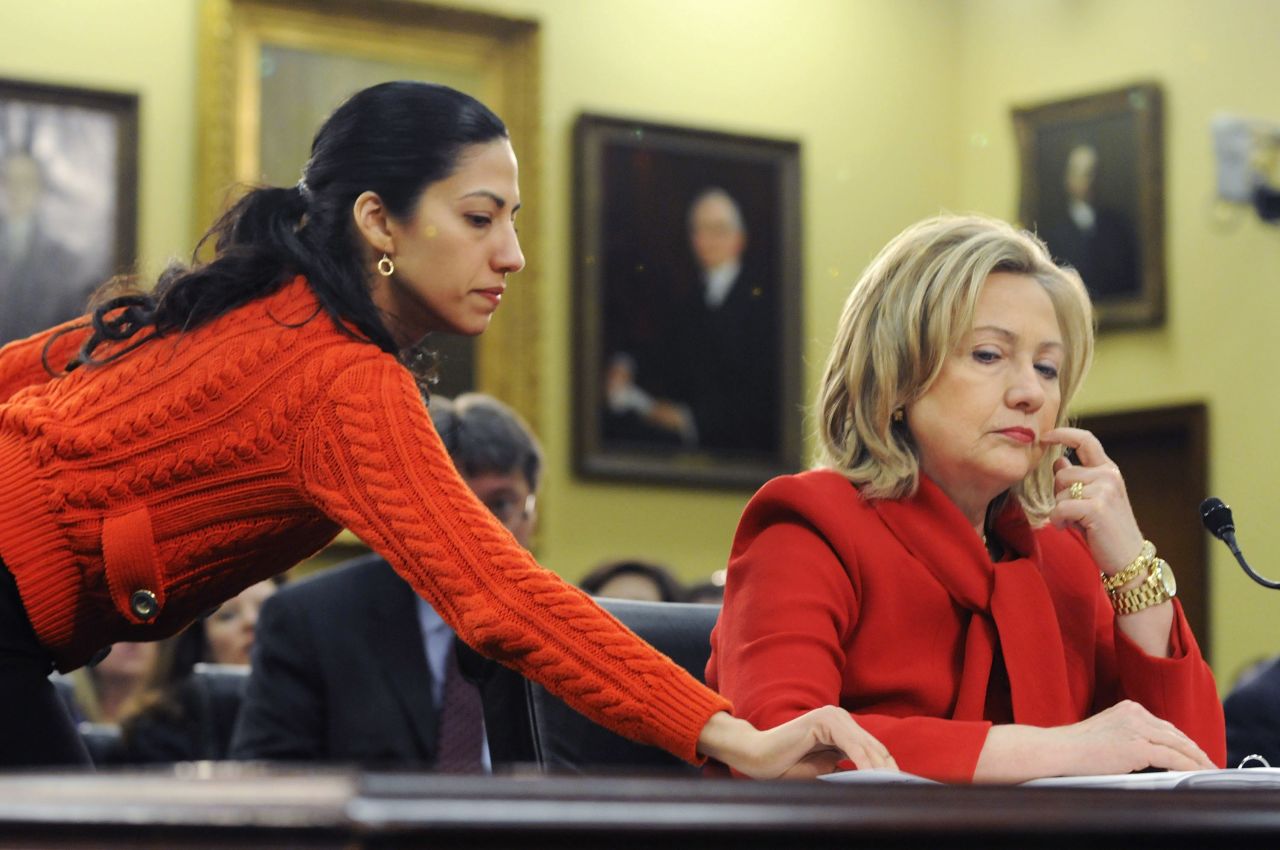 Abedin delivers a note to Clinton on March 10, 2011, during a hearing of the House State, Foreign Operations and Related Programs Subcommittee. She started as a White House intern in 1996. 