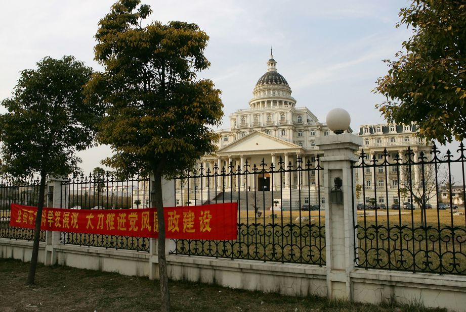 A banner in front of a White House-inspired, 30 million RMB government office building reads, "Pushing forward scientific development, vigorously implement party rules and reduce corruption."