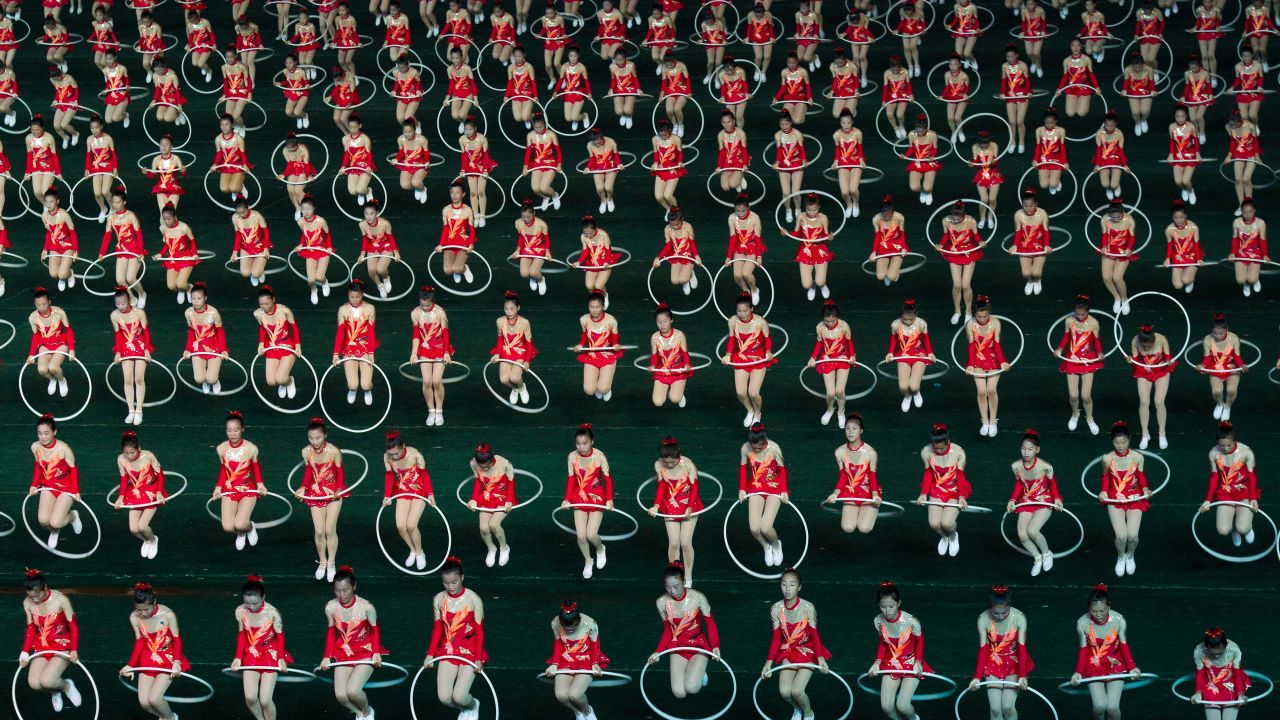 Women jump through hula hoops during the opening night of the annual Arirang Festival, or "mass games," at Pyongyang's May Day Stadium on Monday, July 22.