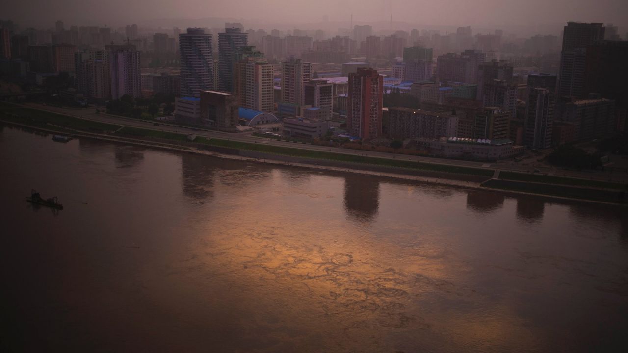 At dusk, the setting sunlight is reflected on the Taedong River in Pyongyang on Sunday, July 21.