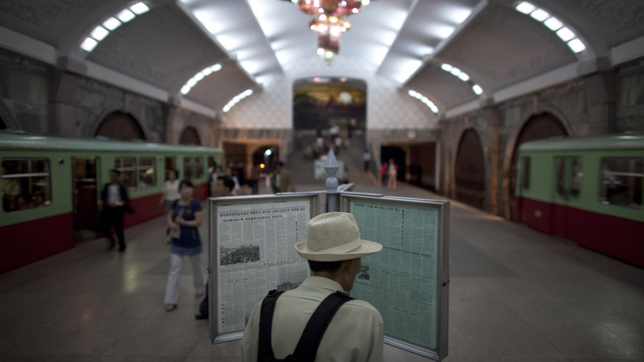 A man reads a newspaper on a public display at Puhung subway station in Pyongyang on Tuesday, June 18. Some stations are more elaborate than others and foreign visitors are usually only allowed to take one stop, from Puhung station to Yonggwang.