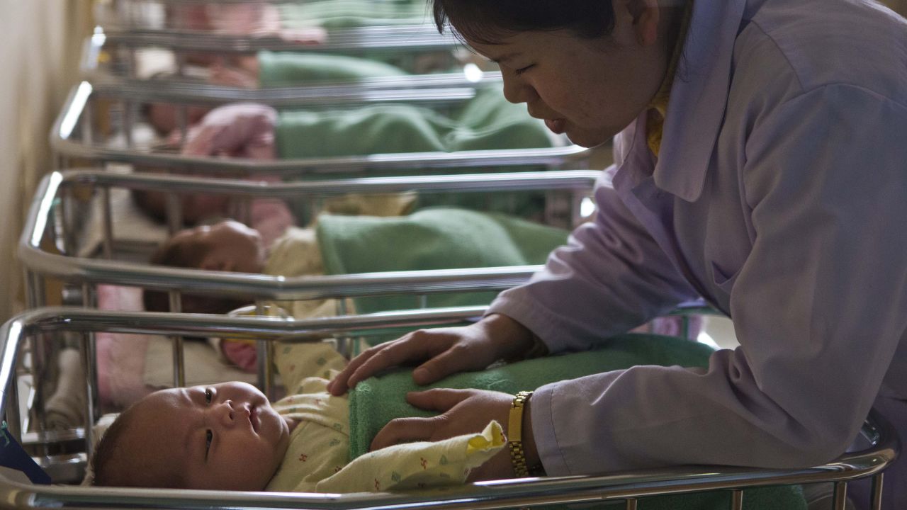 A nurse comforts a baby at a nursery inside Pyongyang Maternity Hospital in Pyongyang on Wednesday, February 20.