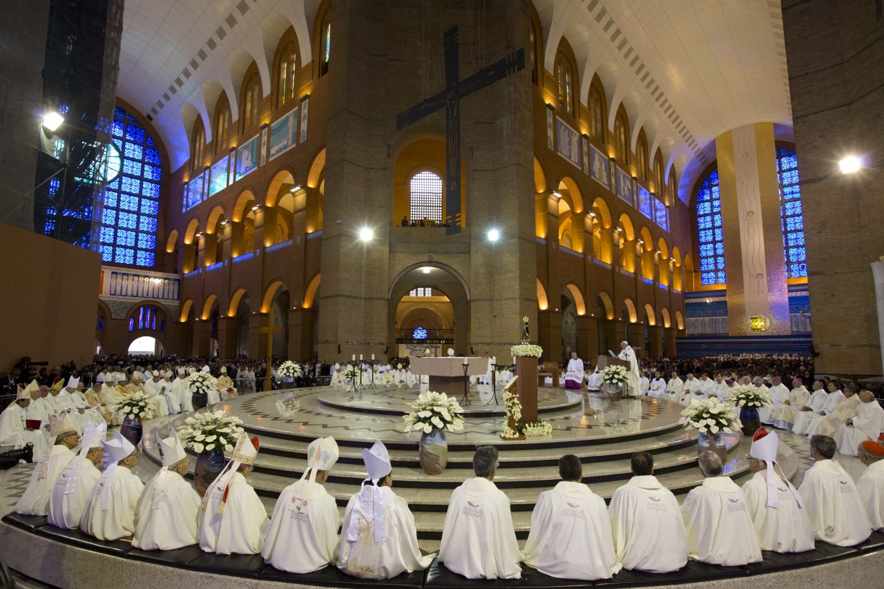 Members of the clergy listen to Pope Francis, center right, as he gives Mass inside the Basilica of Our Lady of Aparecida on July 24.