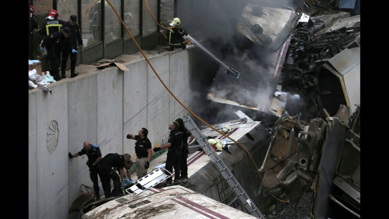 Emergency workers climb on top of the wreckage as they help free injured passengers from the crash.