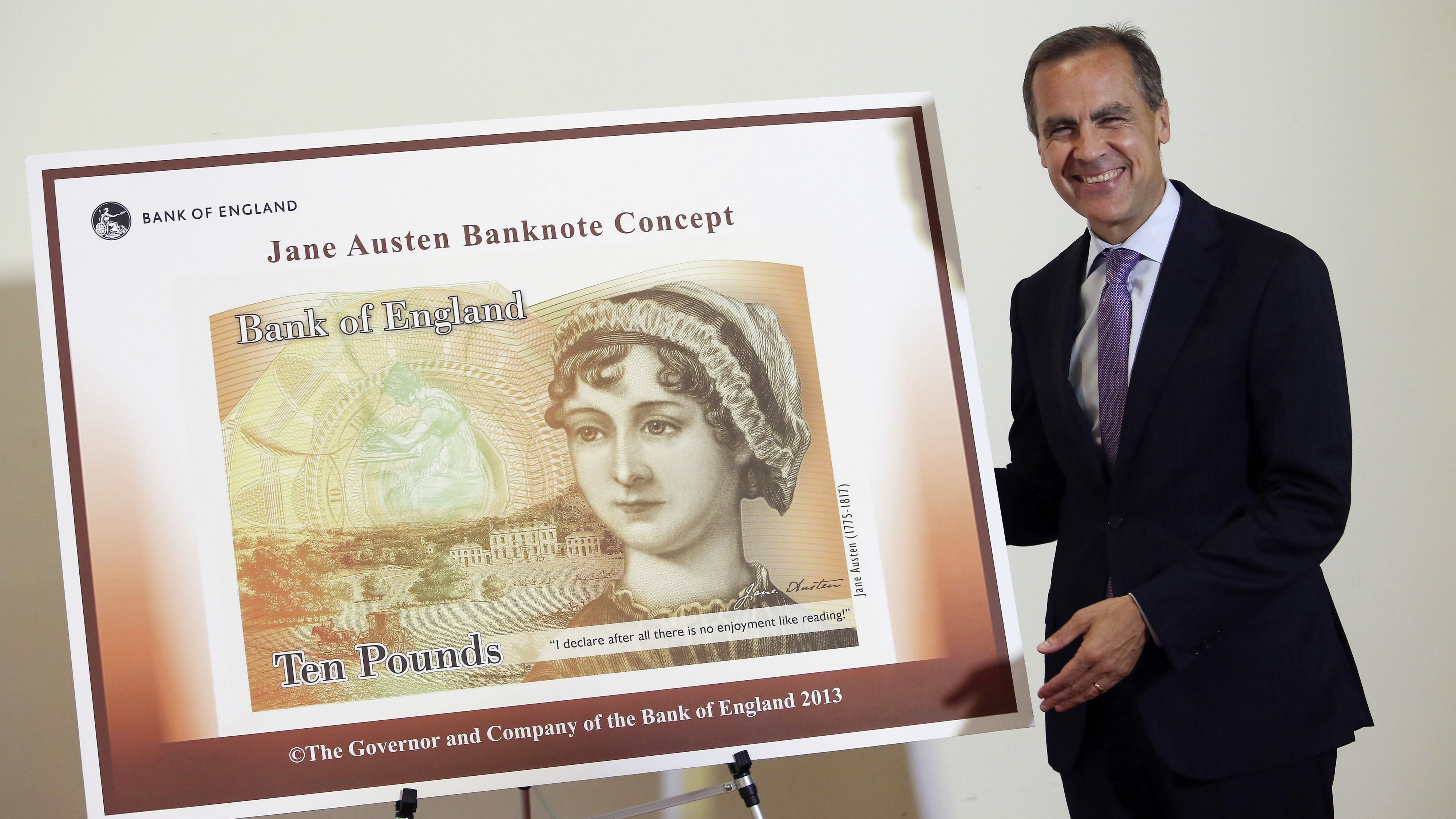 Governor of the Bank of England, Mark Carneystands poses with the concept design for the new Bank of England £10 banknote, featuring author Jane Austen.