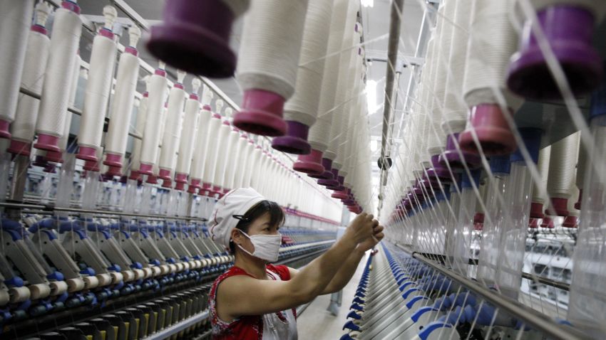 A laborer is seen working in a textile factory in Huaibei, in north China's Anhui province on July 24, 2013. China's manufacturing activity contracted to a 11-month low in July, an HSBC survey showed on July 24, the first evidence of the Asian economic giant losing further momentum in the third quarter. CHINA OUT AFP PHOTO (Photo credit should read STR/AFP/Getty Images)