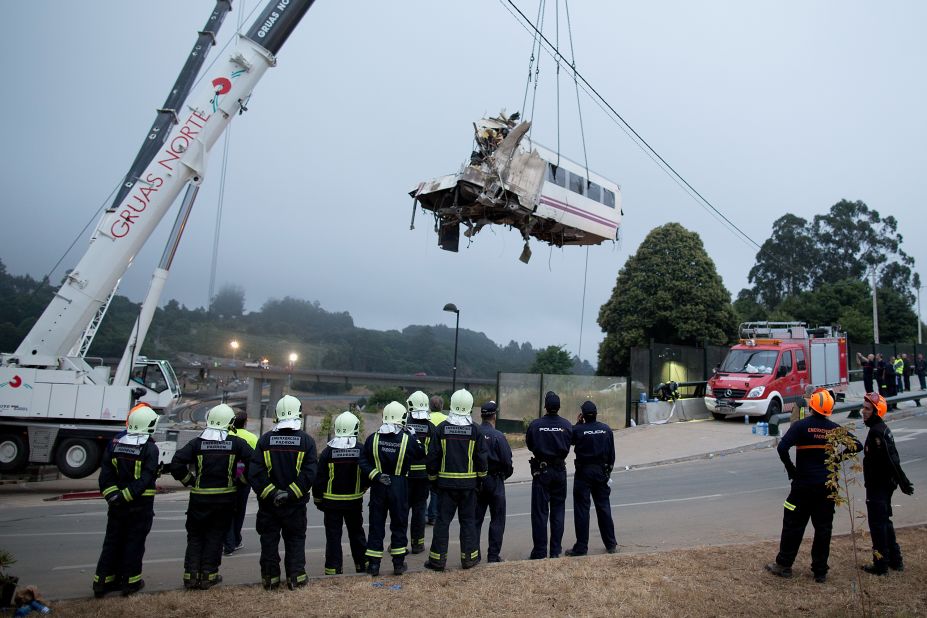 A train car is lifted Thursday, July 25, at Angrois near Santiago de Compostela, Spain. The train derailed as it hurtled around a curve at high speed on Wednesday, July 24.