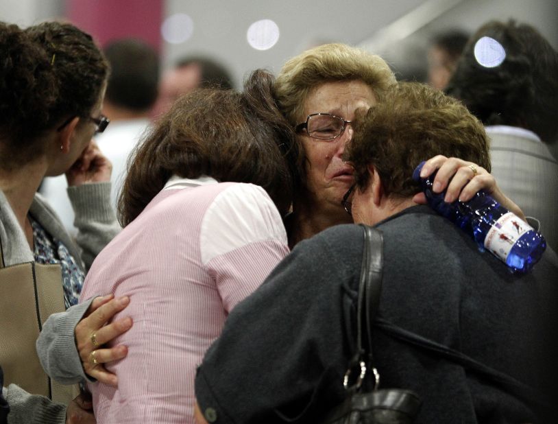 Women wait for news about crash victims in Santiago de Compostela on July 25.