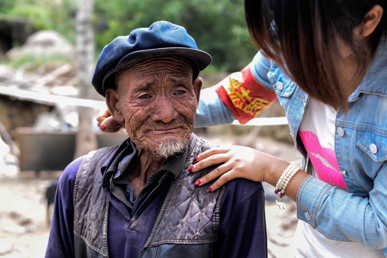 An elderly man weeps on July 24 after he hears he lost his grandson in the earthquake in Yongxing village.