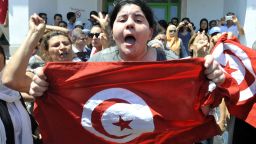 Belkaeis Brahimi, the daughter of Tunisian opposition politician Mohamed Brahmi, shows a national flag shouting outside a hospital after her father was killed on July 25, 2013 in Ariana, outside Tunis. "Mohamed Brahmi, general coordinator of the Popular Movement and member of the National Constituent Assembly, was shot dead outside his home in Ariana, " state media announced. AFP PHOTO / FETHI BELAIDFETHI BELAID/AFP/Getty Images 