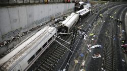 Rescuers, forensics and police officers work at the site of a train accident near the city of Santiago de Compostela on July 25, 2013.