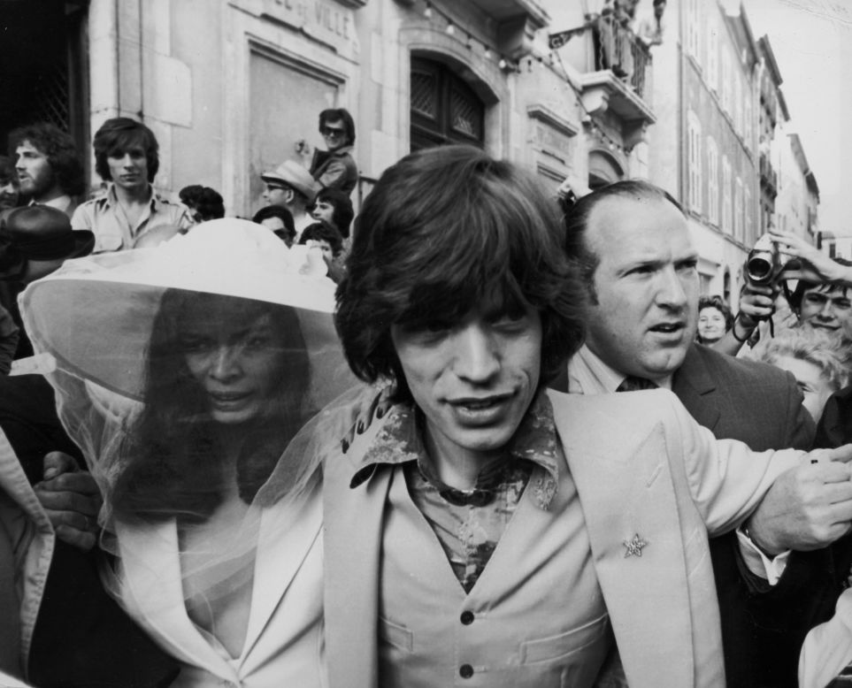 Jagger and his new bride, Bianca Perez Morena de Macias, make their way through the crowds on their wedding day in St. Tropez, France, in 1971.
