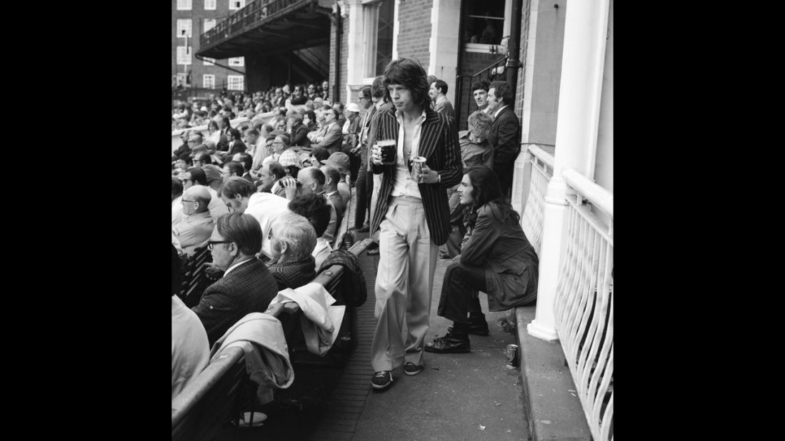 Jagger returns to his seat during a cricket match between England and Australia in 1972.