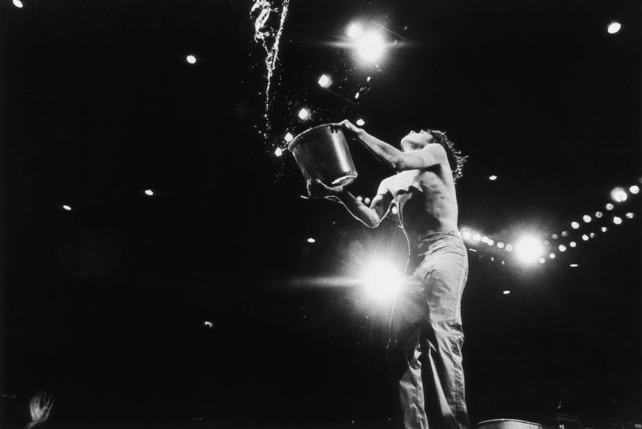 Jagger empties a bucket of water on stage at the 1976 Knebworth Festival in Hertfordshire, England.