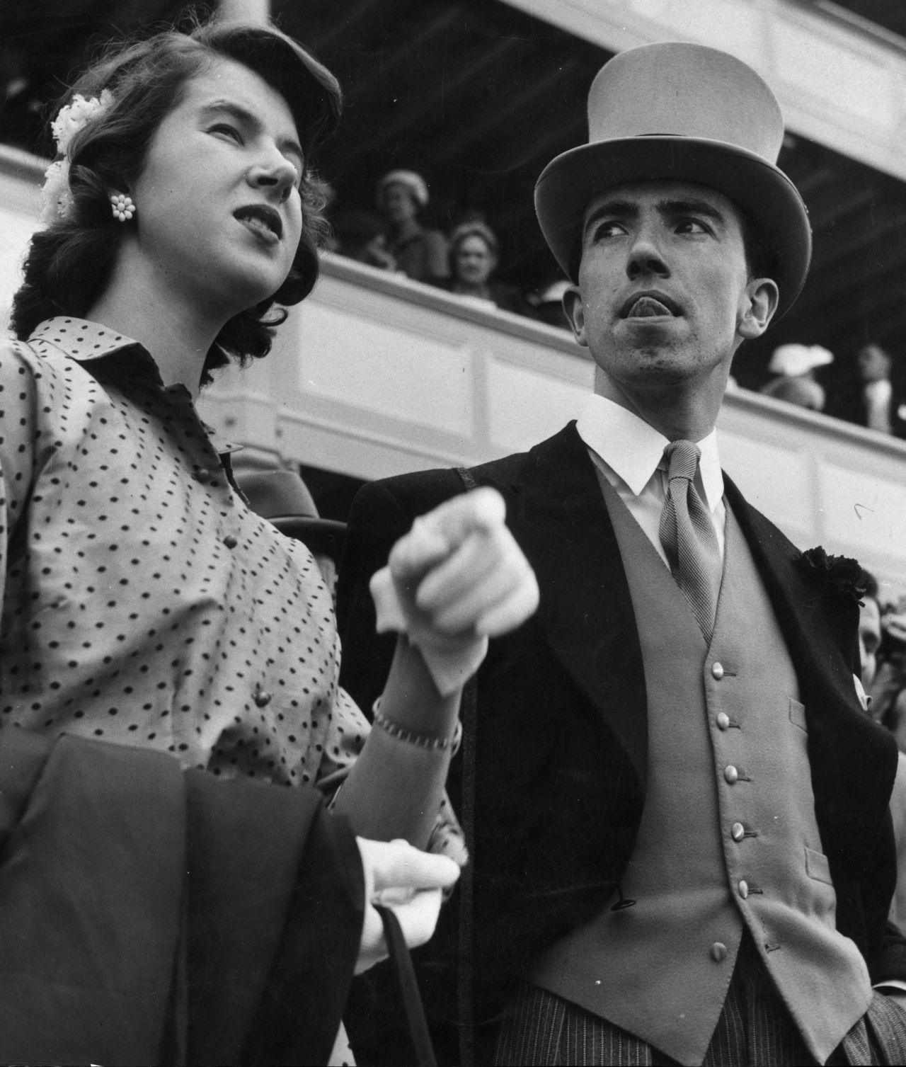 A young debutante and gentlemen friend attend Royal Ascot in 1953.