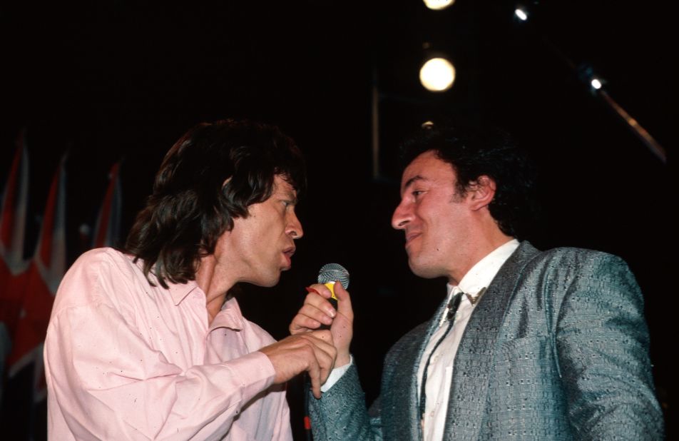 Jagger and Bruce Springsteen share a microphone during the Beatles' induction into the Rock and Roll Hall of Fame in 1988.