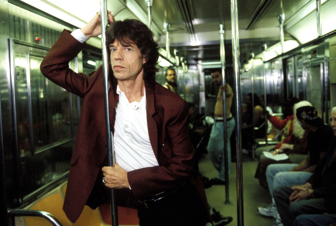 Jagger has his picture taken on a subway in New York in 1997.
