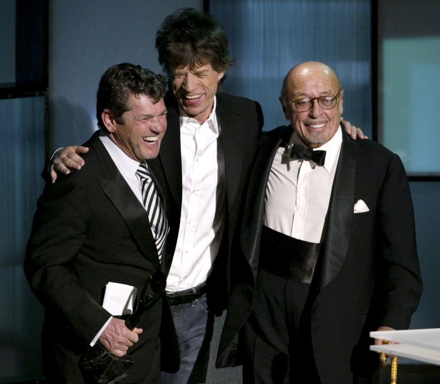 Rolling Stone magazine founder Jann Wenner, left, is presented an award by Jagger and Ahmet Ertegun during the 2004 Rock and Roll Hall of Fame induction ceremony.