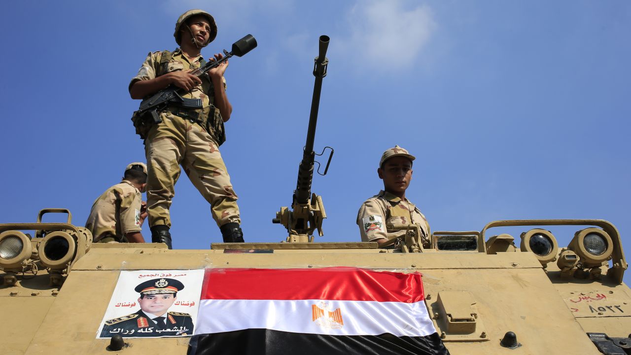 Egyptian soldiers stand guard atop an armored vehicle on a bridge leading to Cairo's Tahrir Square on Friday, July 26.