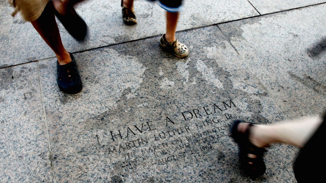 In August 2010, tourists pass the marker commemorating King's 1963 speech on the east steps of the Lincoln Memorial.